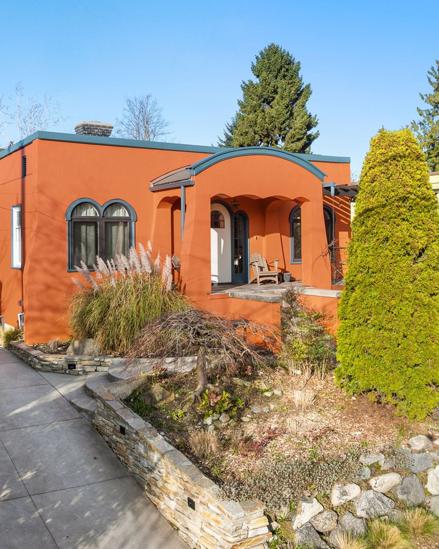 A restored orange Mediterranean-style bungalow VWP listed and sold at 1150 N 77th St in Green Lake, Seattle